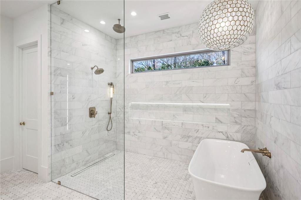 2854 North Thompson Road Northeast Brookhaven, GA 30319 - Photo 18 of 34 a bathroom with a shower and a mirror