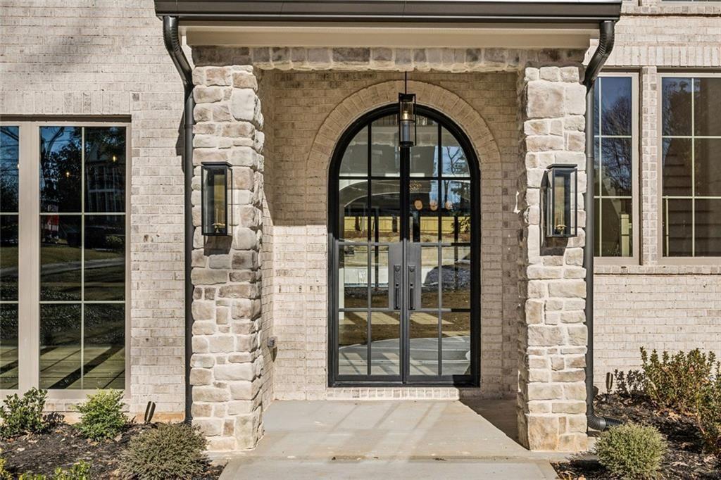 2854 North Thompson Road Northeast Brookhaven, GA 30319 - Photo 2 of 34 a front view of a house with glass windows