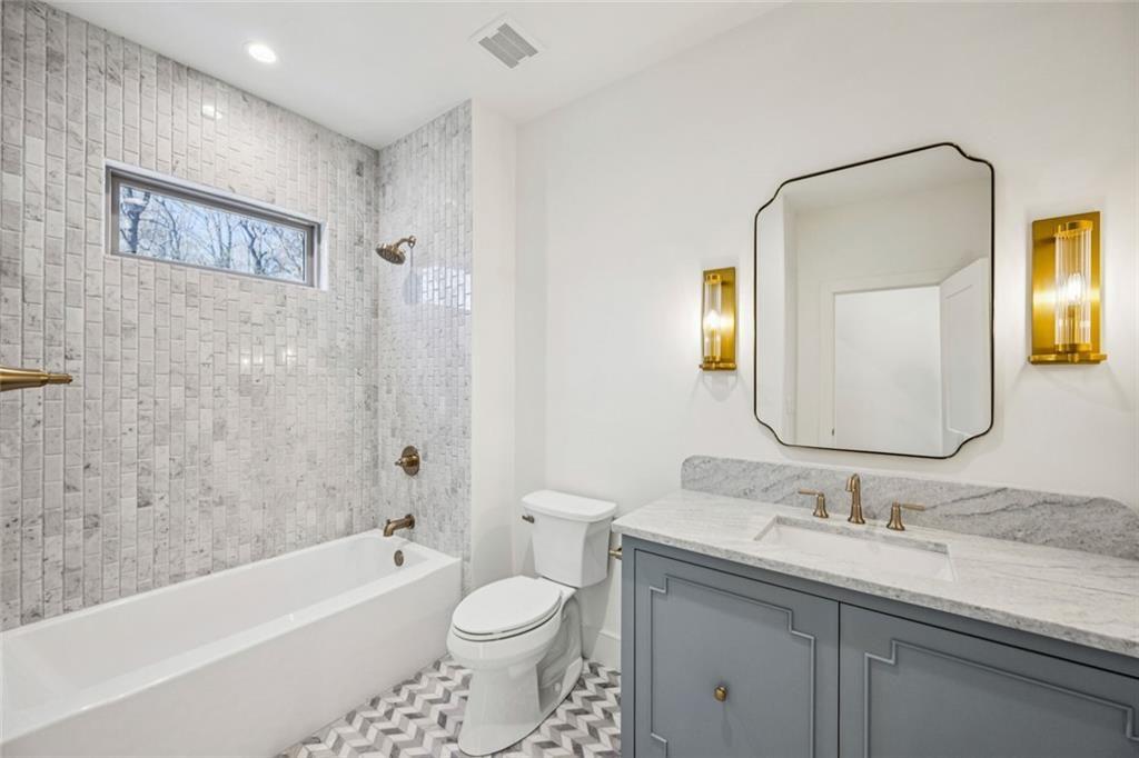 2854 North Thompson Road Northeast Brookhaven, GA 30319 - Photo 25 of 34 a bathroom with a granite countertop sink toilet and shower
