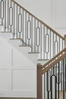 a white building with swimming pool and wooden stairs