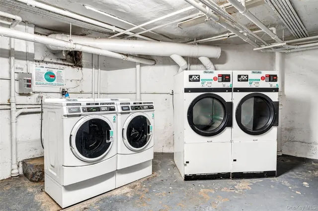 a utility room with dryer washer and a kitchen view