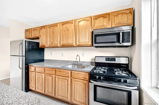 a kitchen with stainless steel appliances granite countertop a stove microwave and cabinets