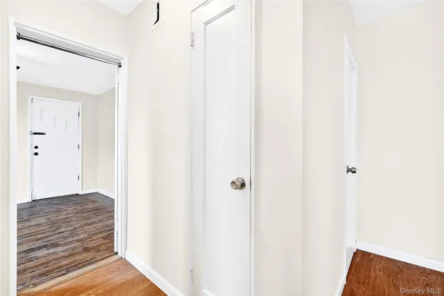 a view of a hallway with wooden floor