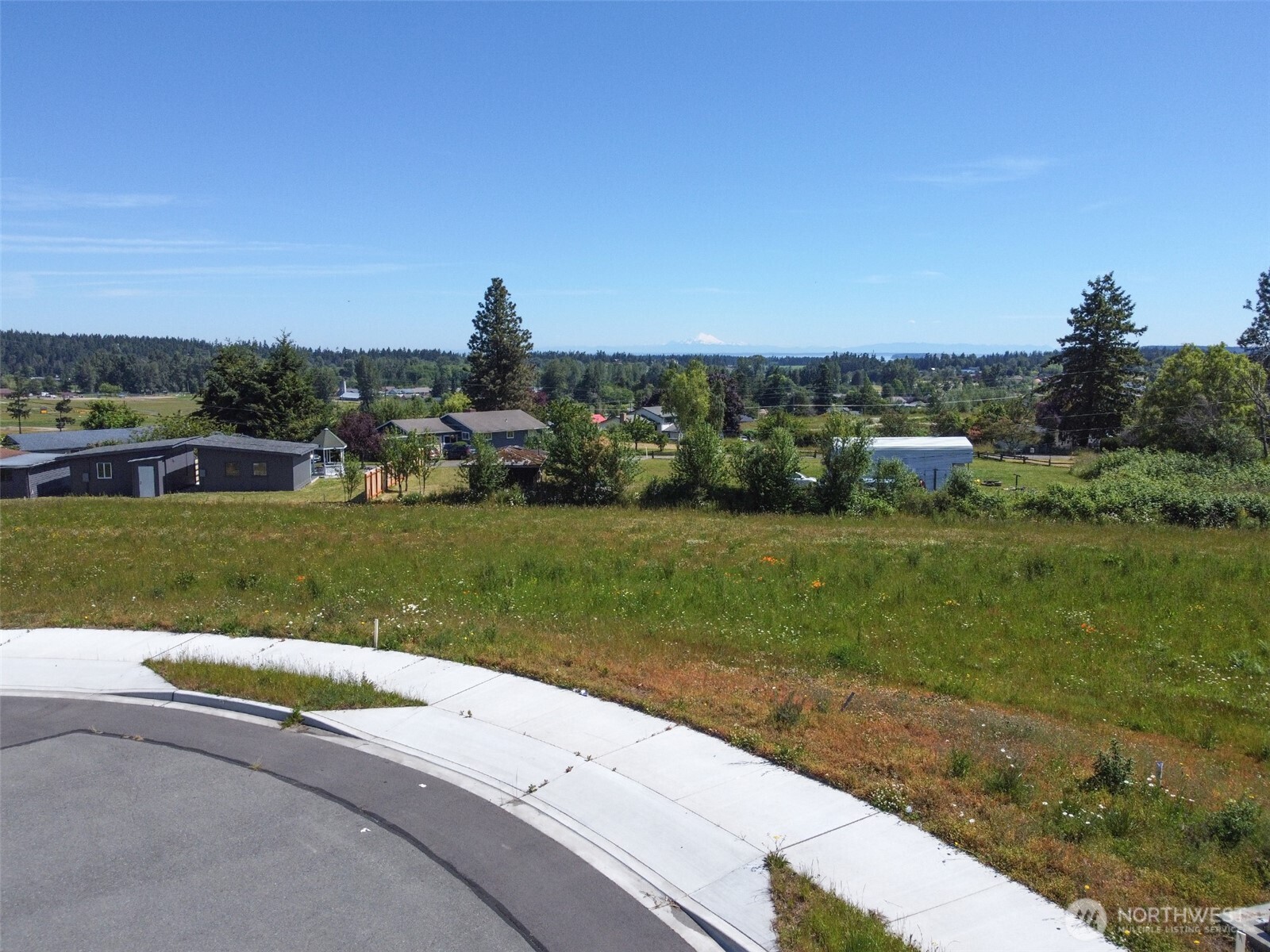 862 South Still Road Sequim, WA 98382 - Photo 15 of 15 a view of a garden with a building in the background