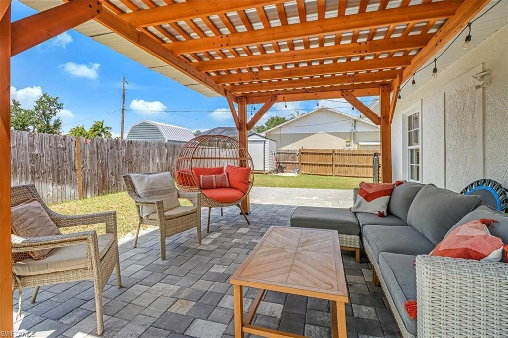 18601 Geranium Road Fort Myers, FL 33967 - Photo 20 of 34 a outdoor living space with patio furniture and a potted plant