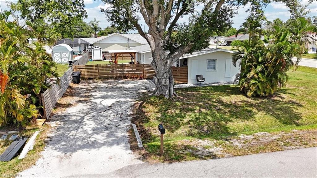 18601 Geranium Road Fort Myers, FL 33967 - Photo 34 of 34 a view of a house with a tree and yard
