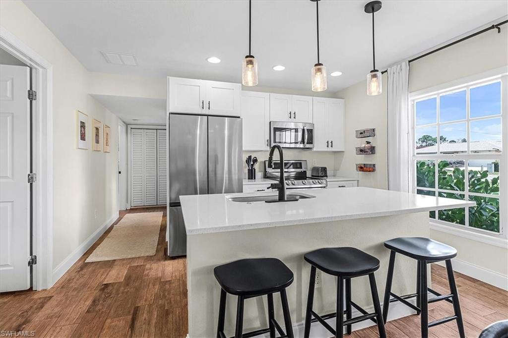18601 Geranium Road Fort Myers, FL 33967 - Photo 6 of 34 a large kitchen with a table and chairs