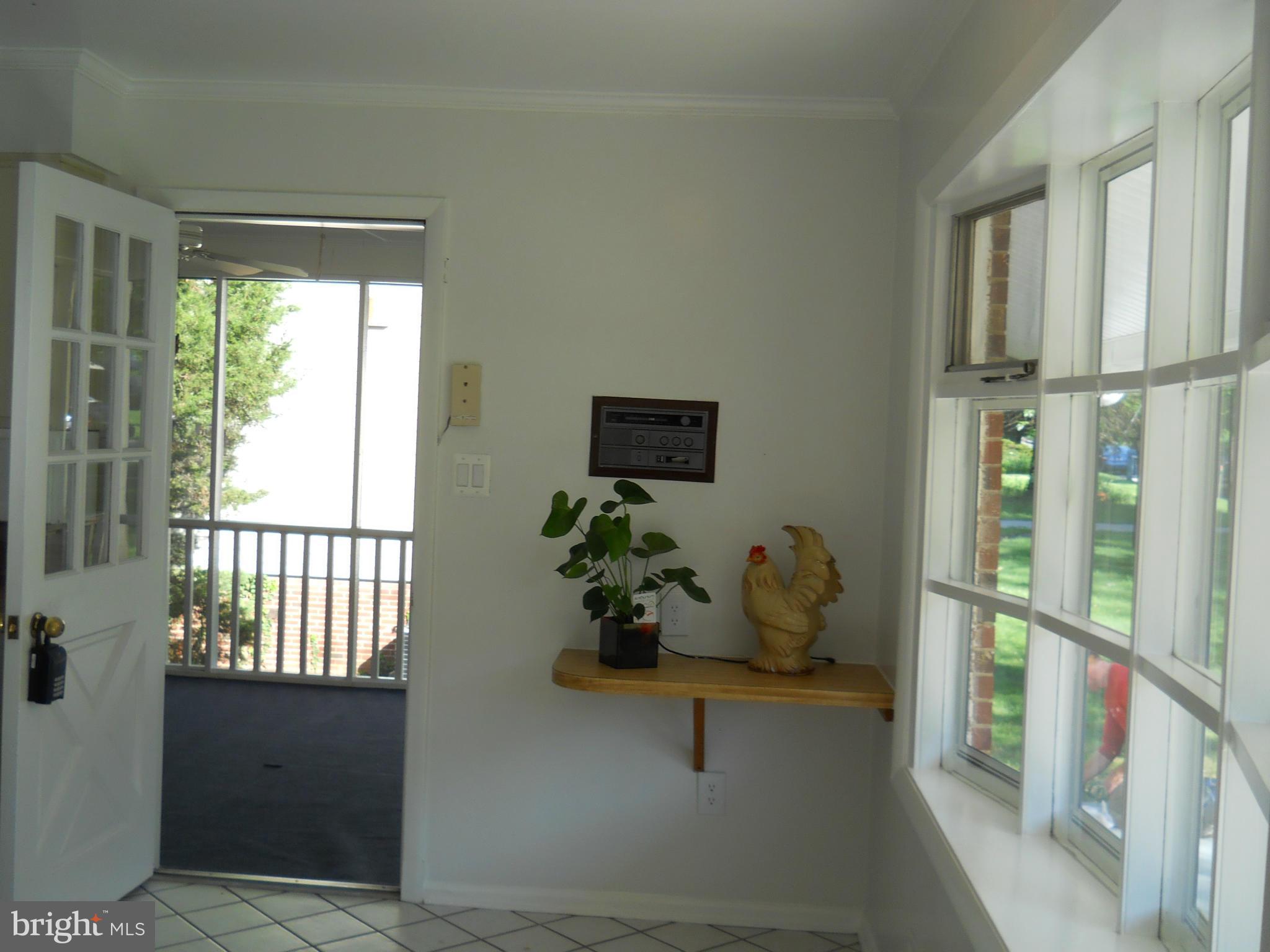 13145 Clifton Road Silver Spring, MD 20904 - Photo 12 of 30 a dining room with wooden floor and a potted plant