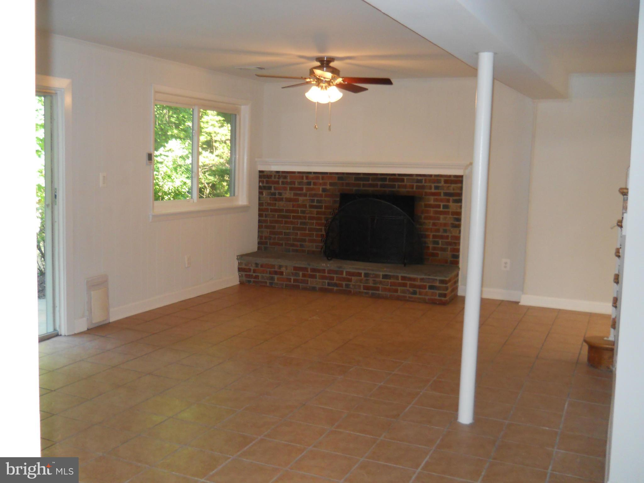 13145 Clifton Road Silver Spring, MD 20904 - Photo 20 of 30 an empty room with windows and fireplace