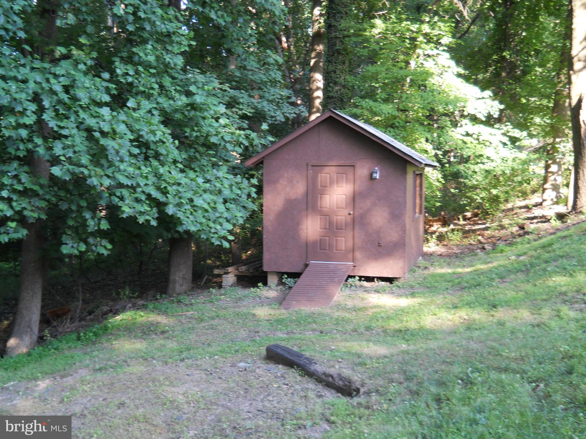 13145 Clifton Road Silver Spring, MD 20904 - Photo 29 of 30 a view of a backyard with a barn and large trees