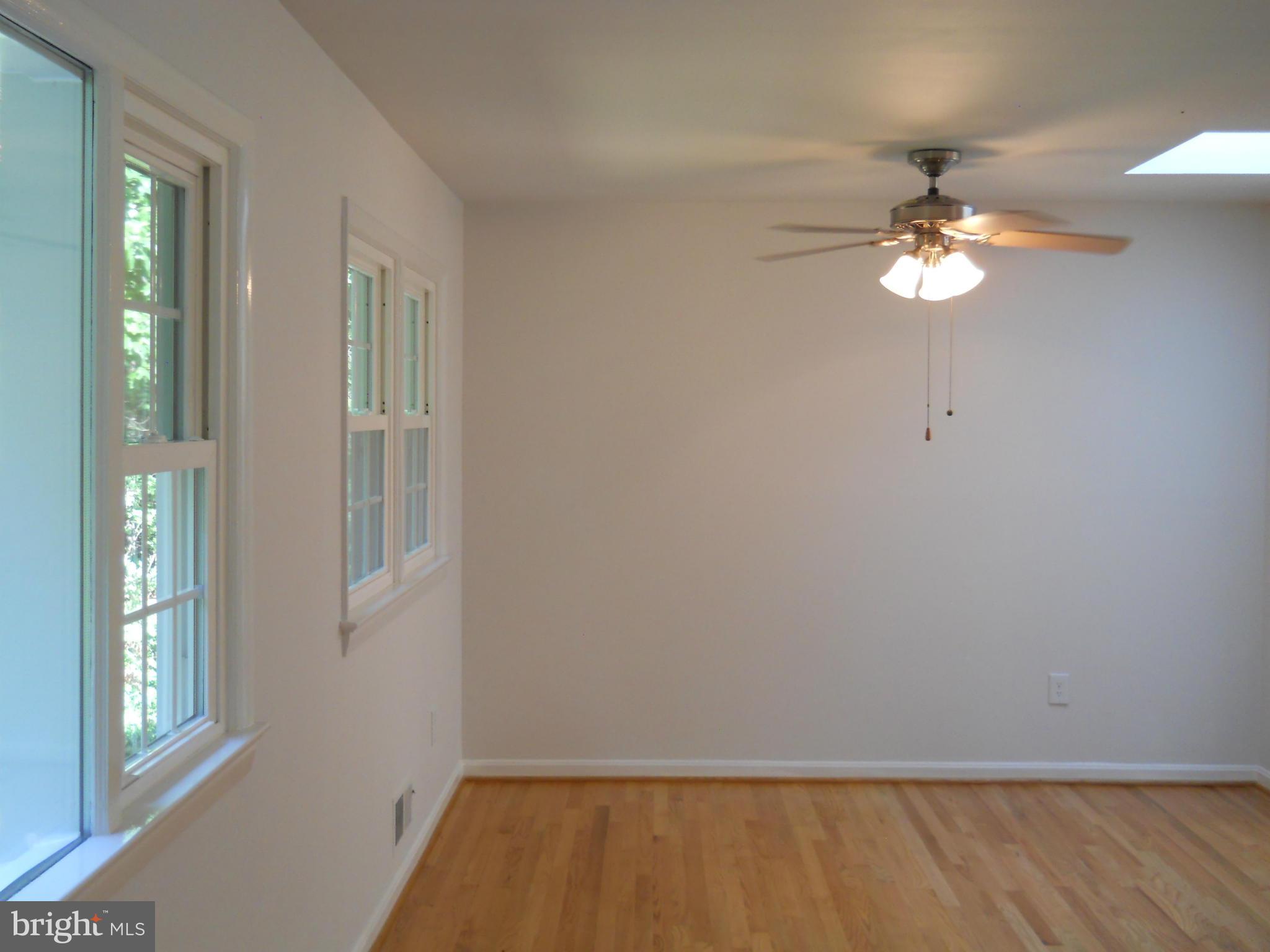 13145 Clifton Road Silver Spring, MD 20904 - Photo 7 of 30 a view of room with chandelier fan and windows