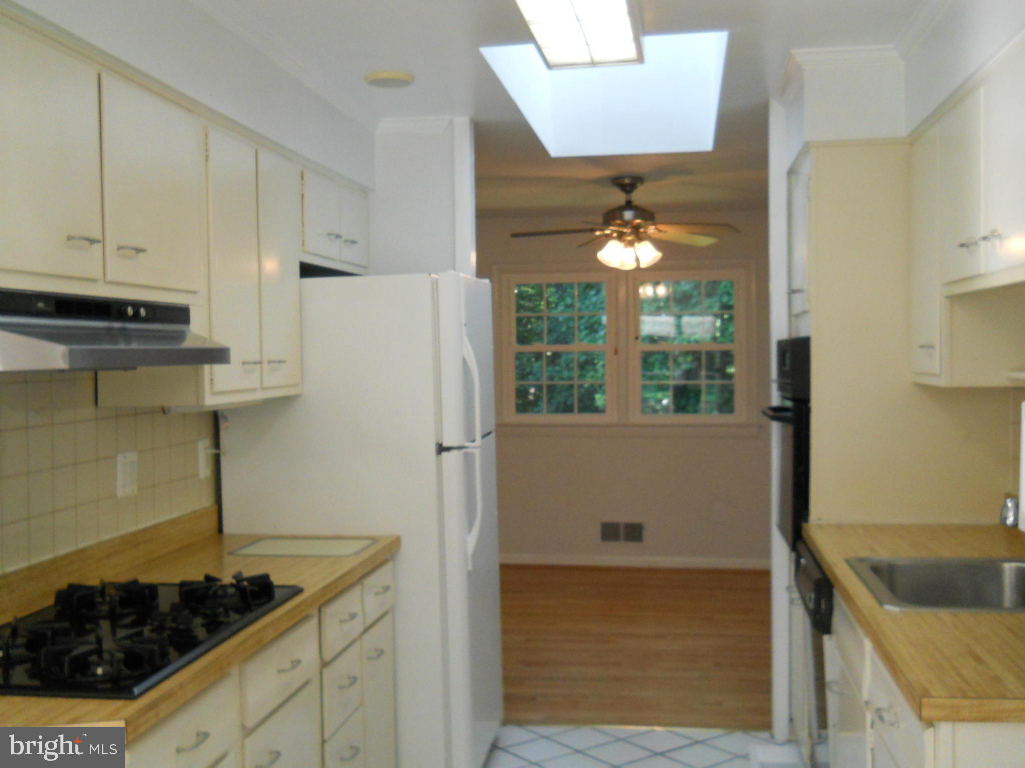 13145 Clifton Road Silver Spring, MD 20904 - Photo 8 of 30 a kitchen with a stove and a refrigerator