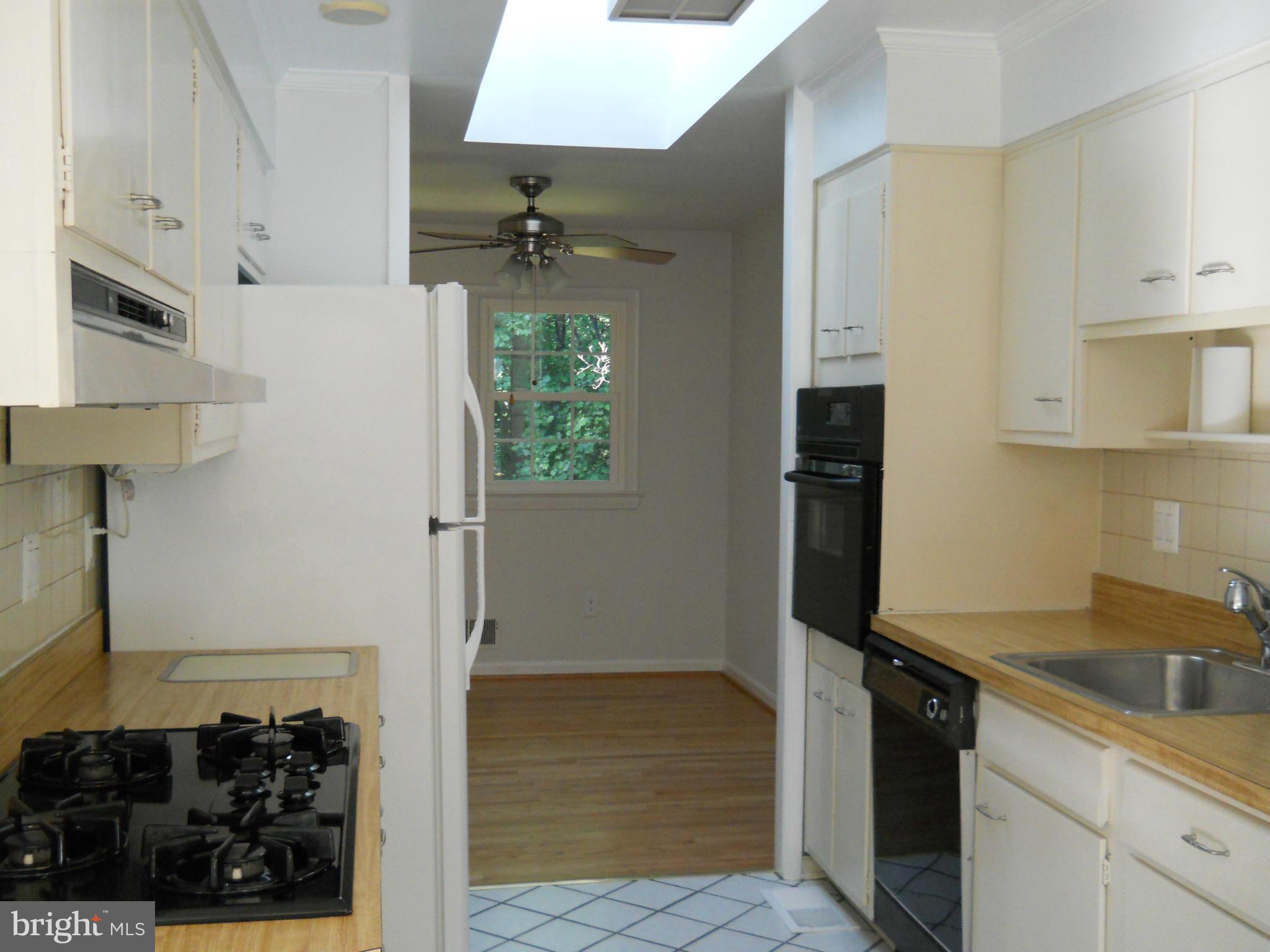 13145 Clifton Road Silver Spring, MD 20904 - Photo 9 of 30 a kitchen with a refrigerator and a sink