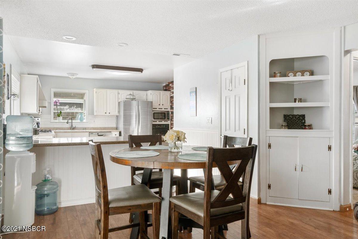 4085 Constellation Road Lompoc, CA 93436 - Photo 12 of 24 a view of a dining room with furniture and wooden floor