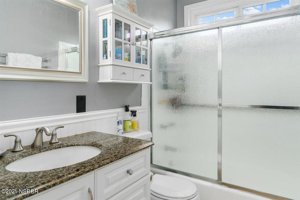 4085 Constellation Road Lompoc, CA 93436 - Photo 17 of 24 a bathroom with a granite countertop sink toilet and shower