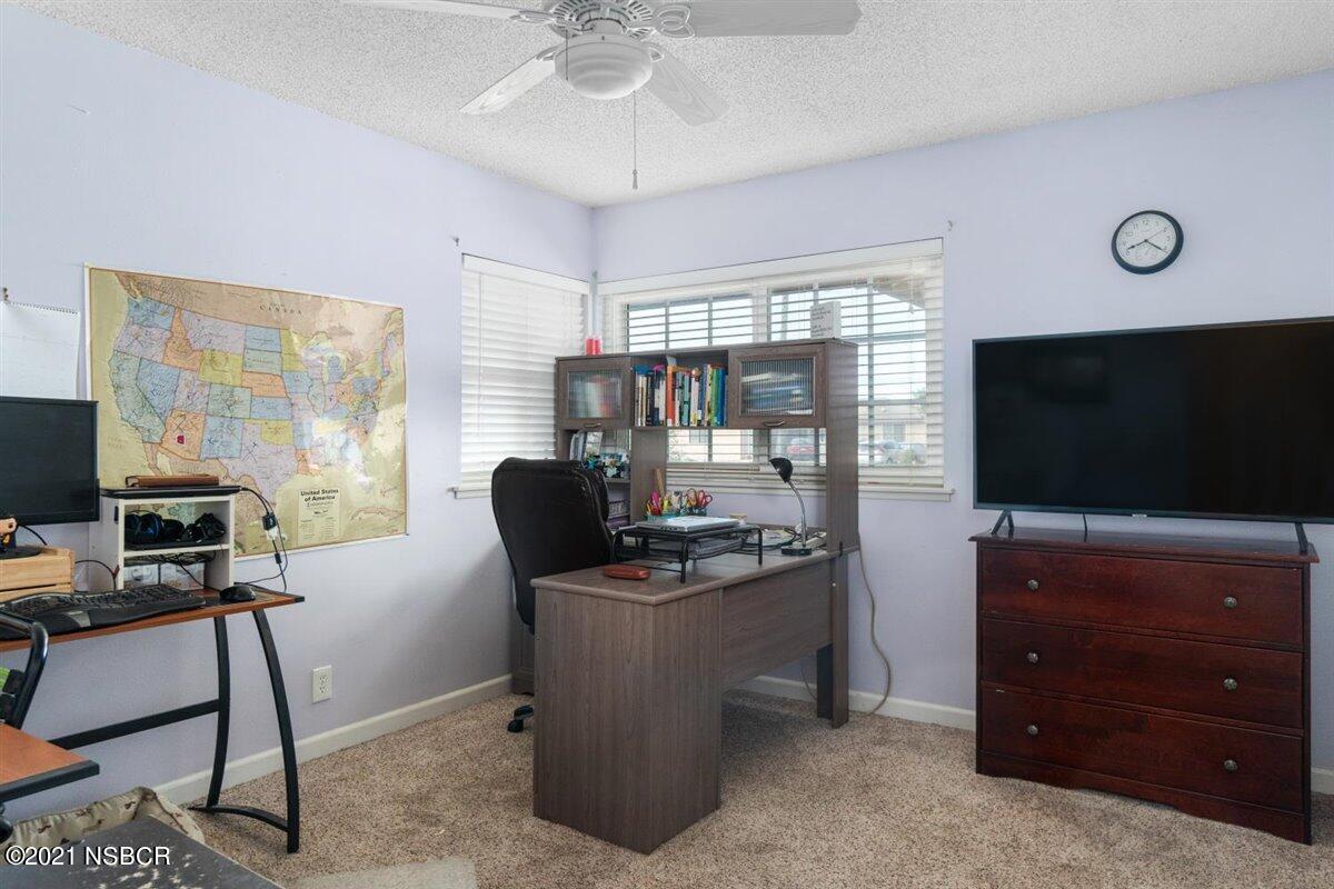 4085 Constellation Road Lompoc, CA 93436 - Photo 19 of 24 a view of a workspace with furniture and a flat screen tv