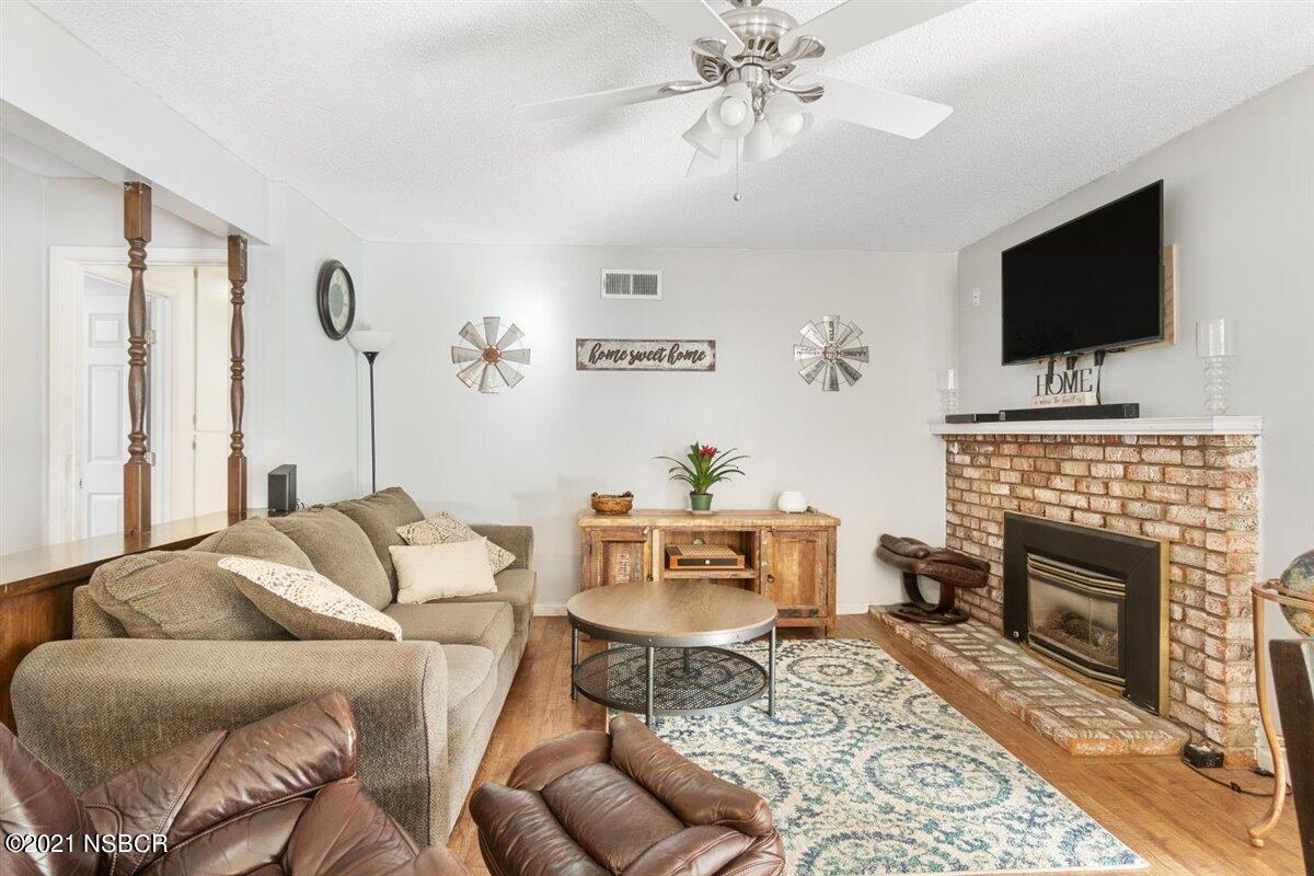 4085 Constellation Road Lompoc, CA 93436 - Photo 6 of 24 a living room with furniture a flat screen tv and a fireplace