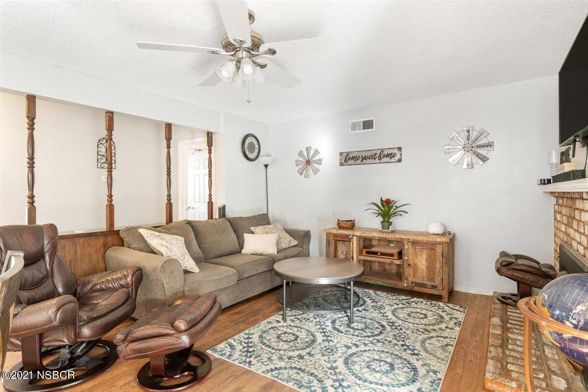 4085 Constellation Road Lompoc, CA 93436 - Photo 7 of 24 a living room with furniture a rug and a chandelier