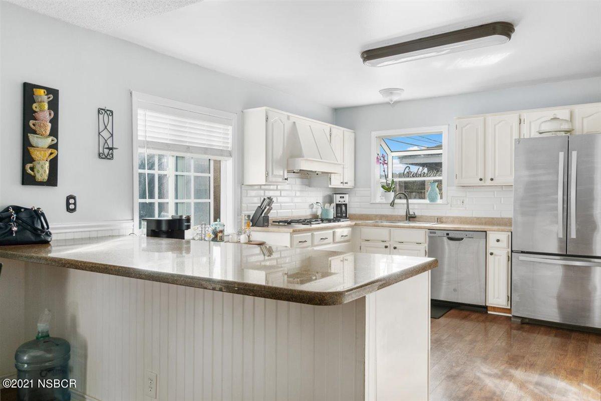 4085 Constellation Road Lompoc, CA 93436 - Photo 9 of 24 a kitchen with stainless steel appliances granite countertop a sink a stove and refrigerator