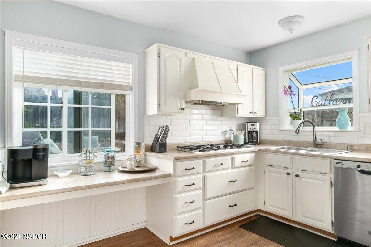 4085 Constellation Road Lompoc, CA 93436 - Photo 10 of 24 a kitchen with stainless steel appliances white cabinets and a sink