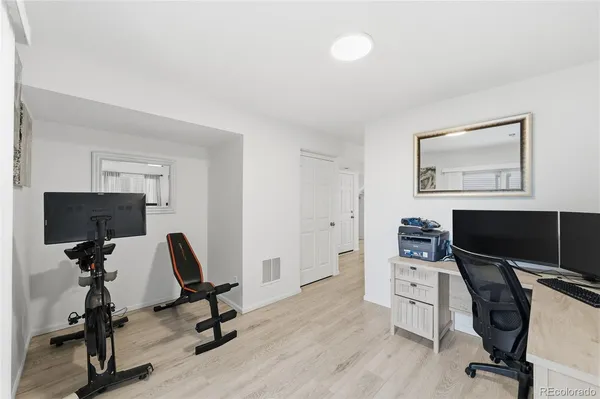 a view of a workspace with furniture and a window