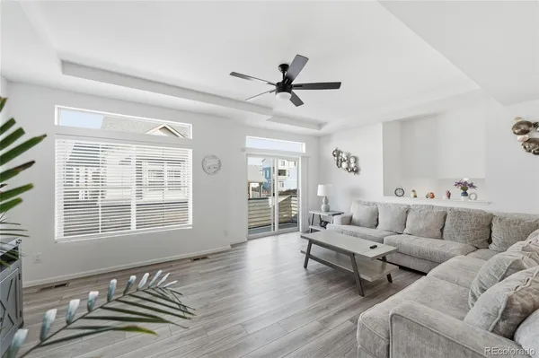 a living room with furniture and wooden floor