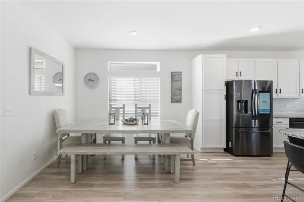 a dining room with furniture and wooden floor