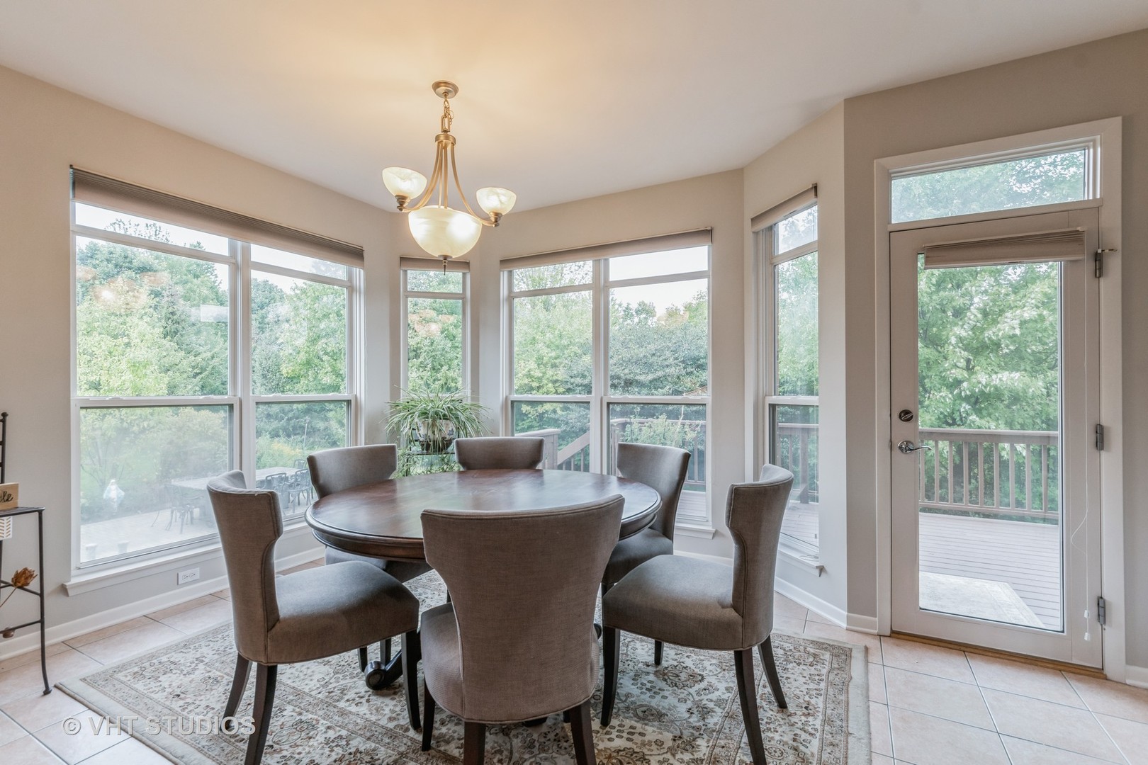 190 Janes Loop Highwood, IL 60040 - Photo 13 of 34 a view of a dining room with furniture large windows and wooden floor