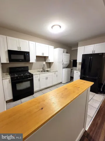 a kitchen with stainless steel appliances a refrigerator sink and microwave