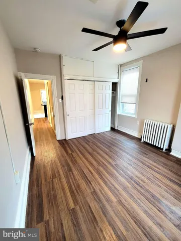 a view of a livingroom with wooden floor and furniture