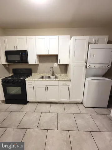 a kitchen with a stove a sink and a refrigerator