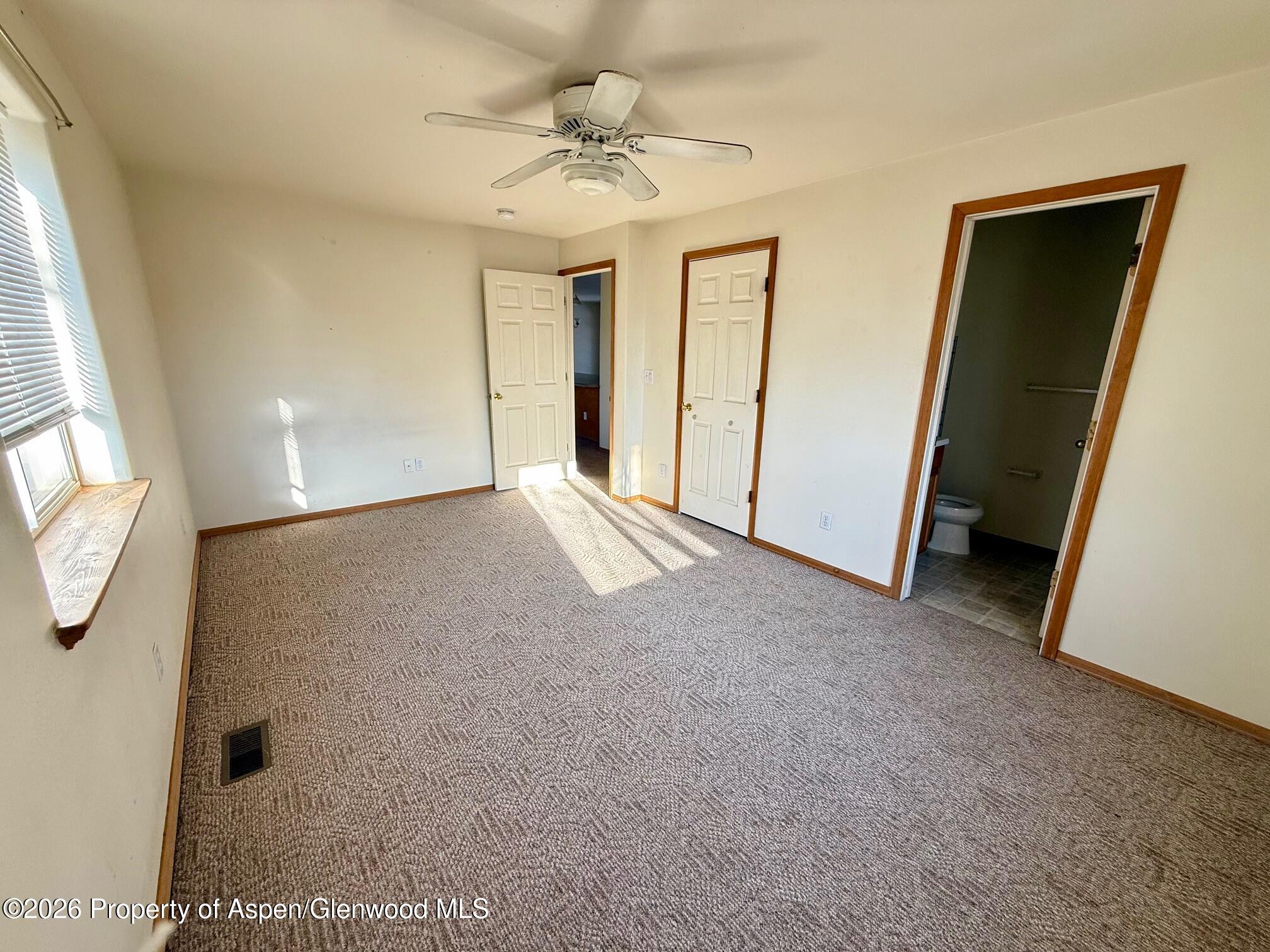 1333 East Victory Way Craig, CO 81625 - Photo 6 of 12 an empty room with windows and entrance