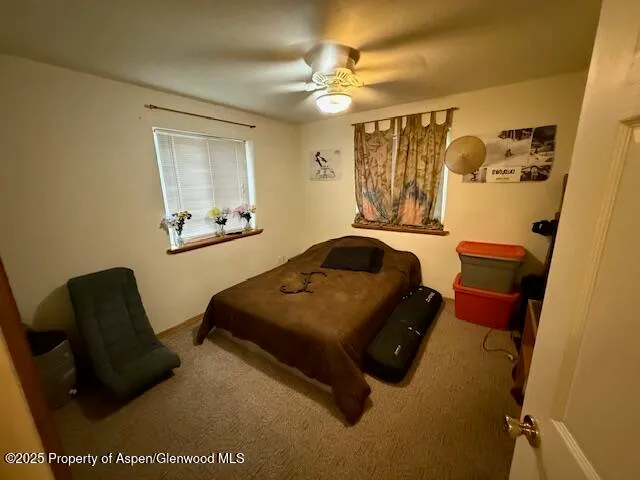 a living room with furniture and a air conditioner vent