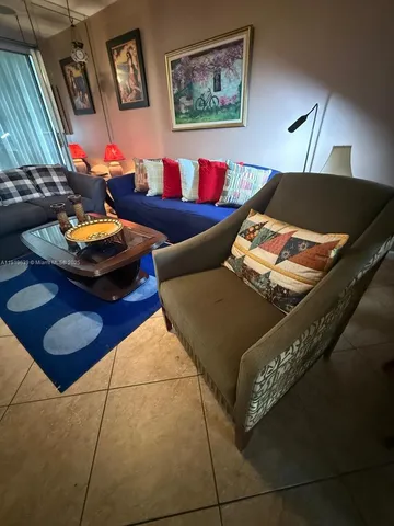 a living room with furniture and a lamp