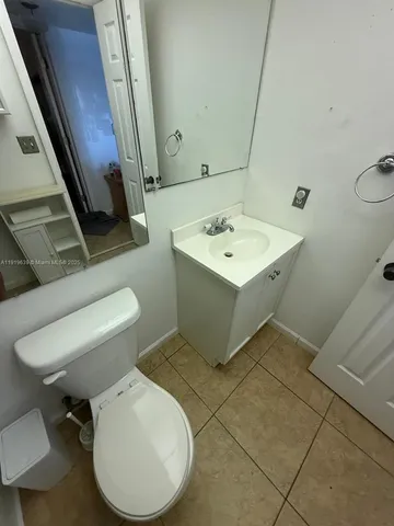 a white toilet sitting next to a bathroom sink