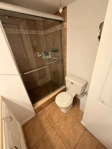 a bathroom with a granite countertop shower and a sink