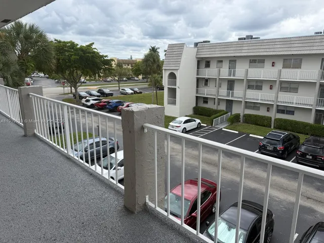 a view of a balcony with book shelf and outdoor seating