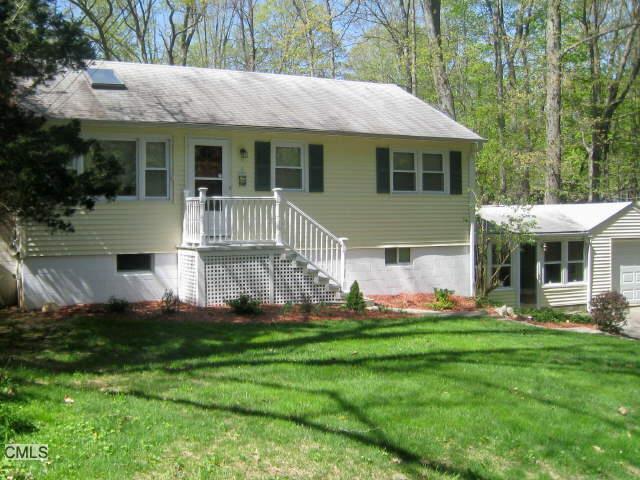 37 Woodland Way Ridgefield, CT 06877 - Photo 1 of 1 a front view of house with yard and green space
