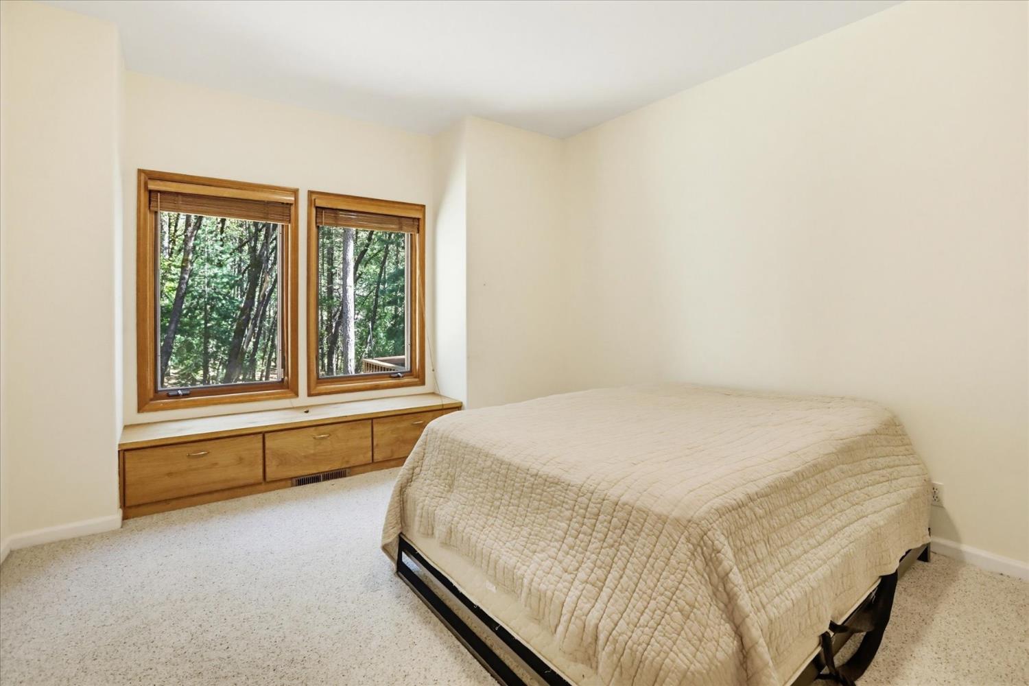 14517 North Bloomfield Road Nevada City, CA 95959 - Photo 34 of 78 a bed sitting in a bedroom next to a window