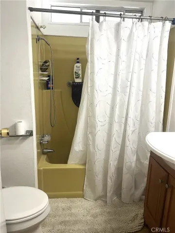 a bathroom with a toilet and a tub