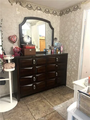 a room with a dresser and a mirror