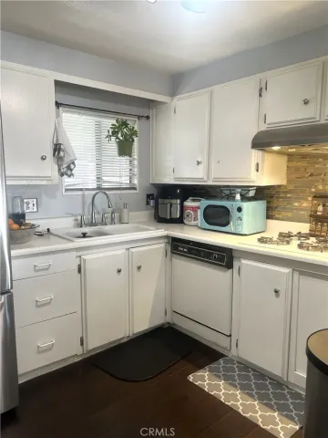 a kitchen with sink cabinets and window