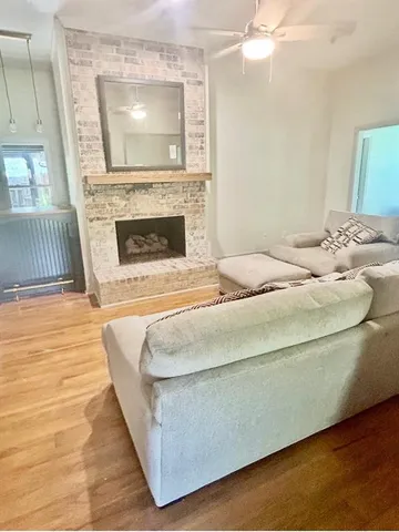 a living room with furniture and a fireplace