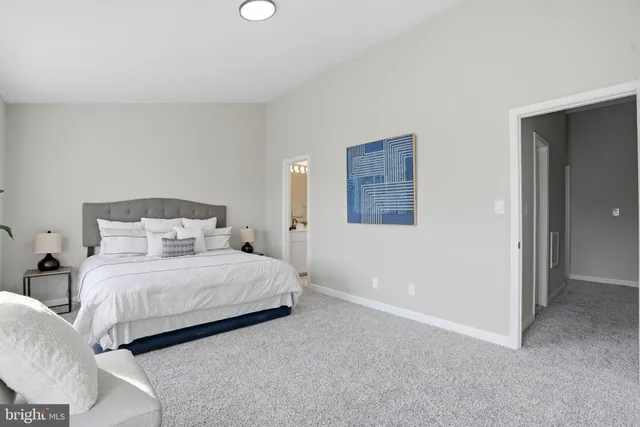 a bedroom with a bed and a lamp