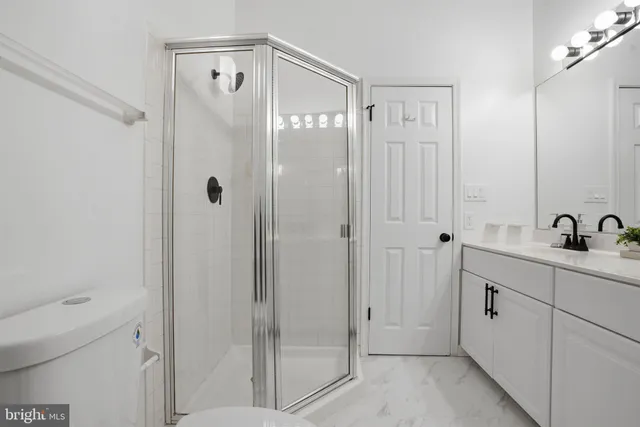 a bathroom with a shower sink and mirror