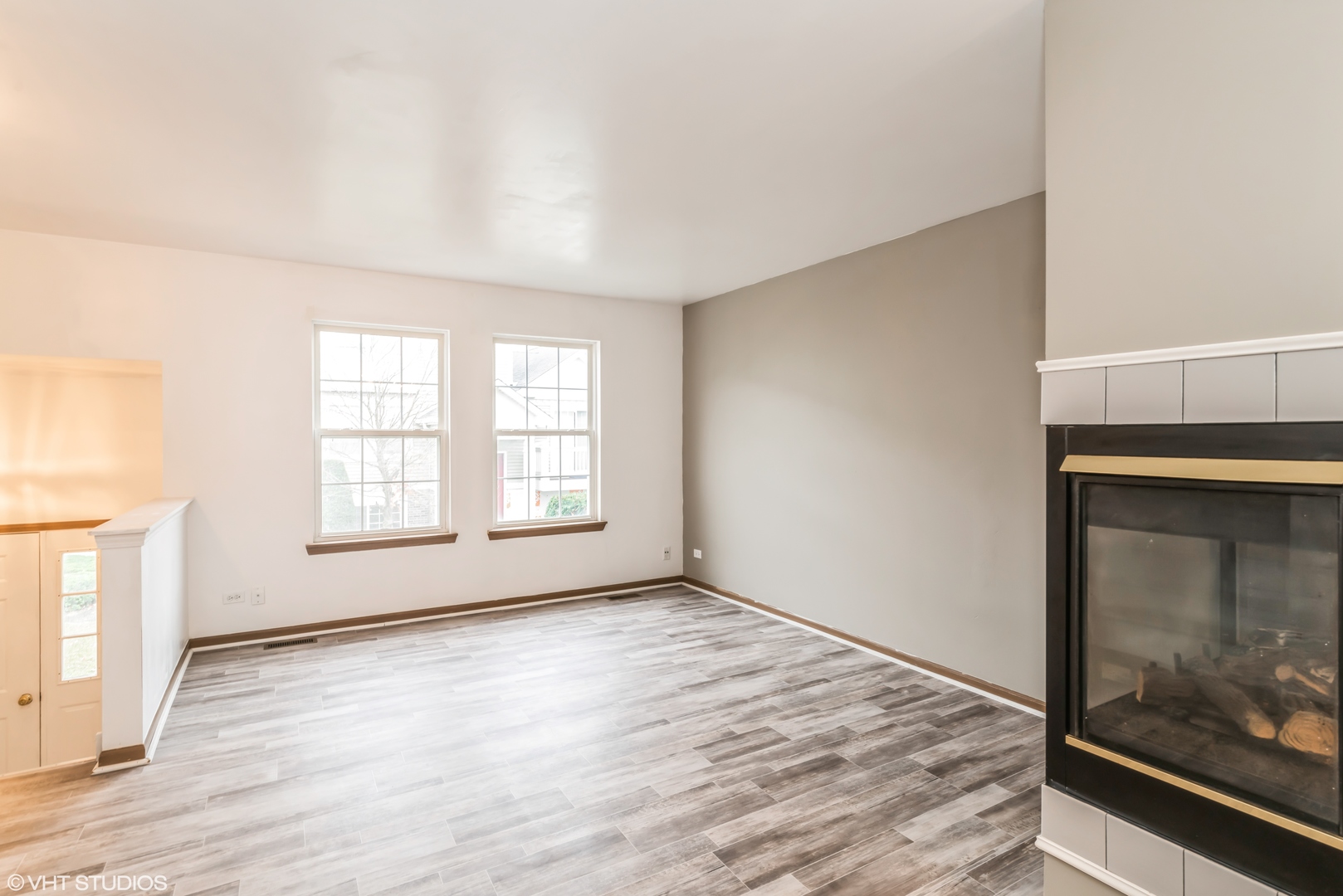 274 Holiday Lane Hainesville, IL 60073 - Photo 4 of 20 a view of an empty room with wooden floor and a window