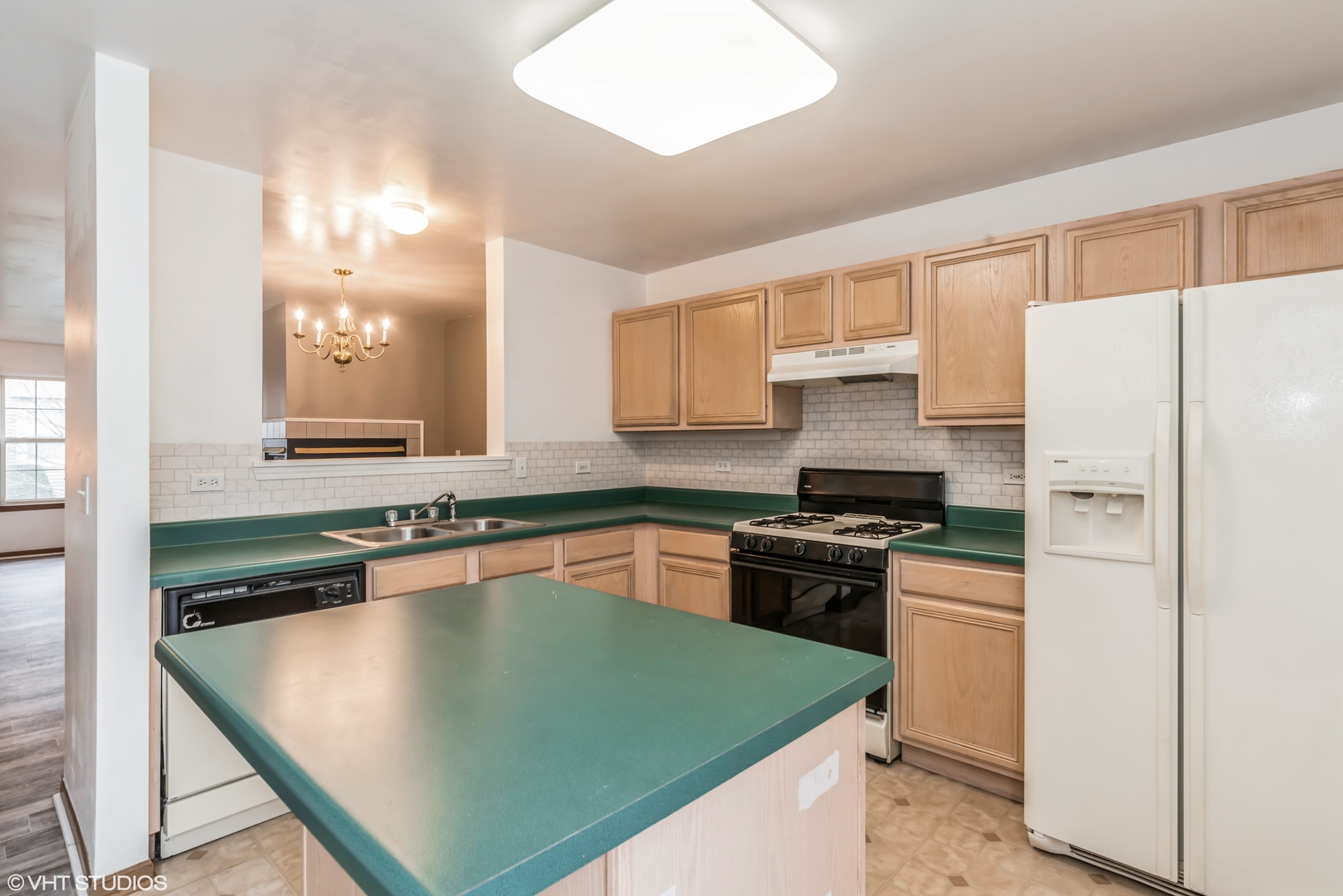274 Holiday Lane Hainesville, IL 60073 - Photo 6 of 20 a kitchen with granite countertop a sink stove and refrigerator