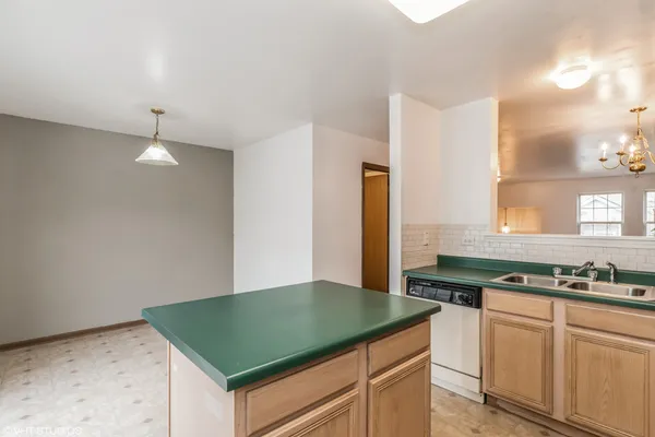 a kitchen with sink and cabinets