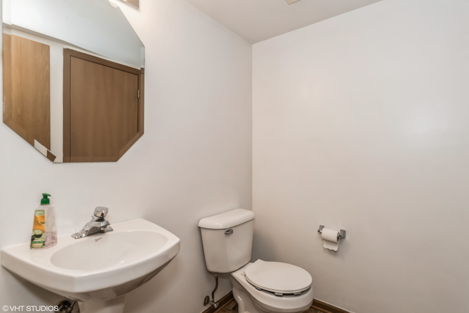 274 Holiday Lane Hainesville, IL 60073 - Photo 8 of 20 a bathroom with a sink a mirror and a toilet