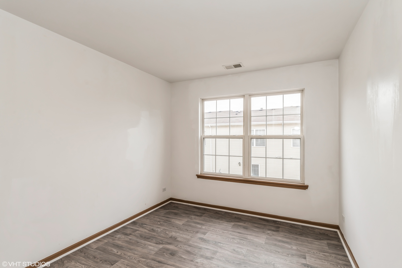 274 Holiday Lane Hainesville, IL 60073 - Photo 10 of 20 an empty room with wooden floor and windows